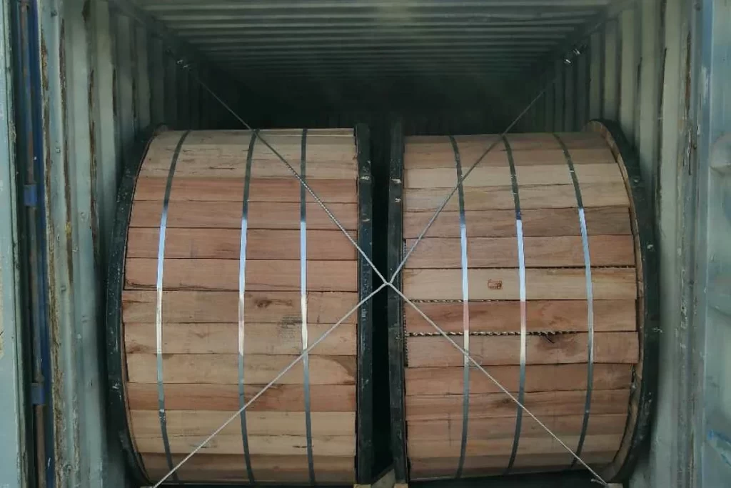 Wooden cable drums secured inside a shipping container